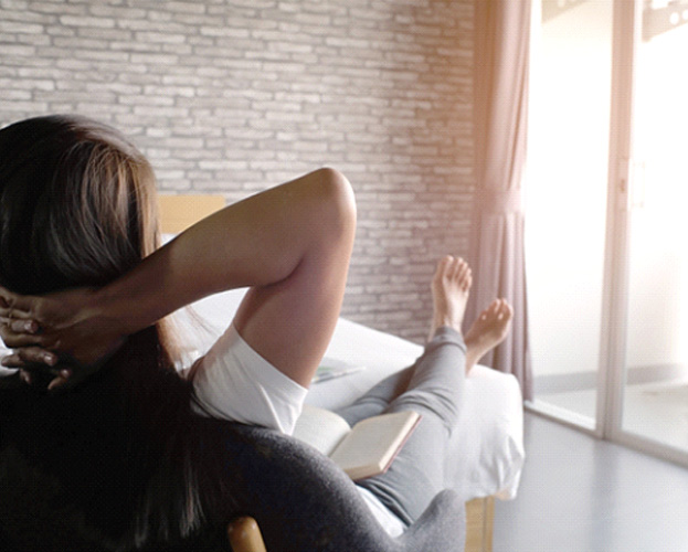 person relaxing at home after a tooth extraction