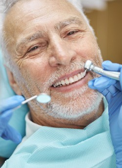 patient smiling while visiting dentist 