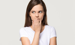 nervous woman biting her nails