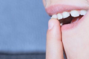 closeup of a child’s mouth with a loose tooth