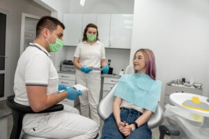 dentist and patient talking about teeth whitening